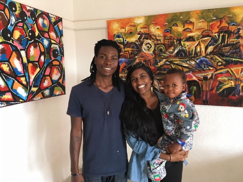 JMV posing in front of some of his art with my friend and fellow squad leader Ashley as well as JMV's son named Hapiness