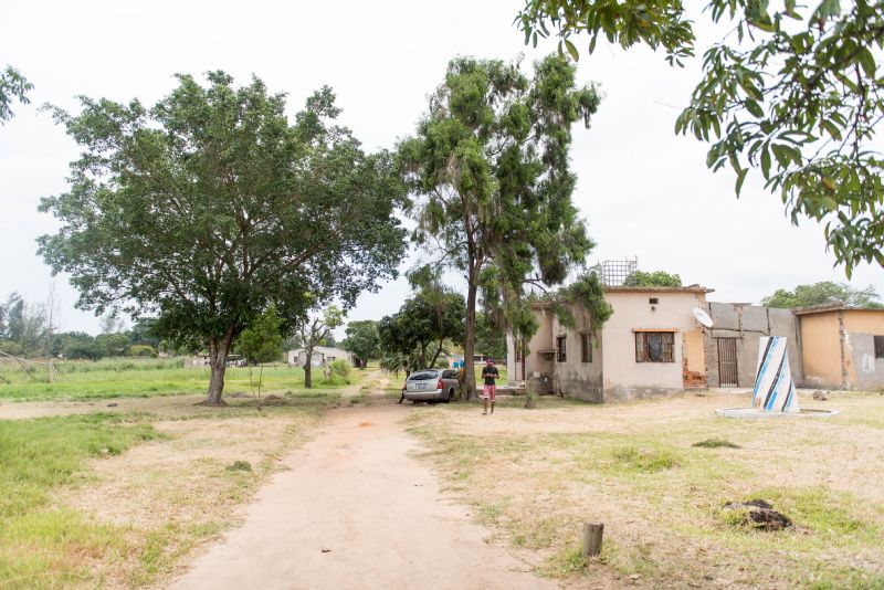 A view of the whole compound -- the Hope House in the foreground and Angie's house, the two storage houses, and the outside kitchen in the background