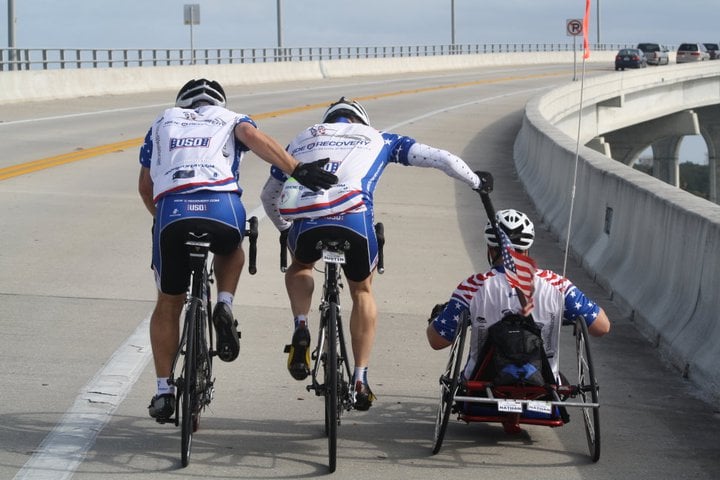 Clay helping a fellow injured veteran during Ride2Recovery challenge