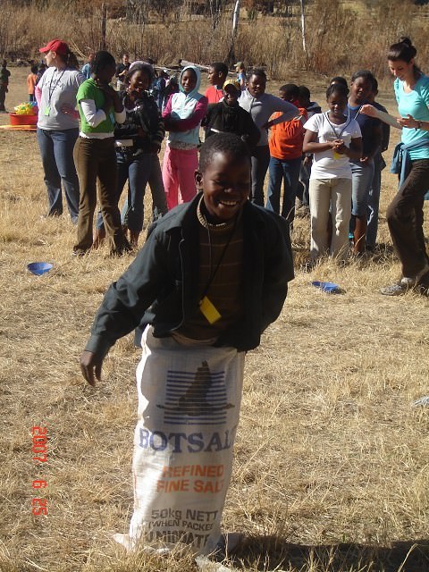 One of our campers at Refilwe finishing a relay race during recreation time