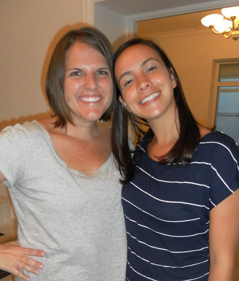 Kids shoes left on the rocky shore and a half popped raft against the rocks