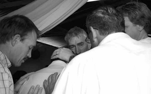 Seth, Andrew Shearman, Bob Waag (back to us) and Gary Black pray over a mexican pastor