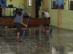 Cleaning the sanctuary floor with brooms & water
