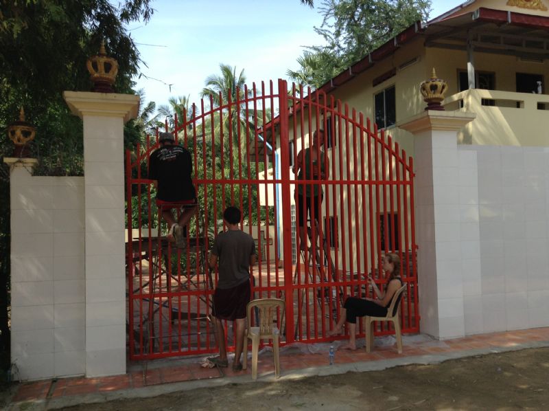 Team & painting the gates of the church in Prey Veng