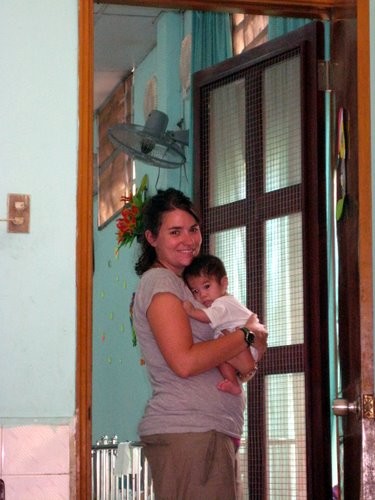 Jen holding a Vietnamese baby.