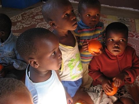 Kids with Oranges at School House