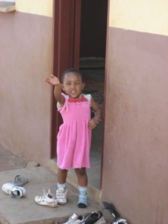little girl at door of school house saying good-bye