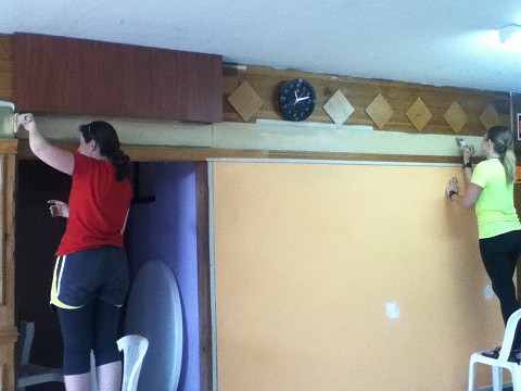 Abby and Jurie beginning to paint the walls at the church!