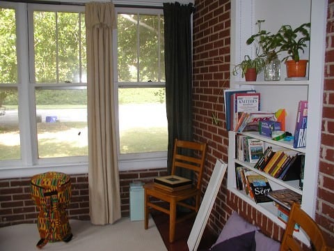 The front sun room...my favorite space in the house.  The ugly chairs will be replaced with comfy ones to make awesome reading spaces.  yay!