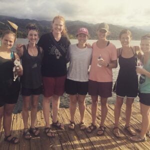 This is my team, squad leader, and I in Honduras. We are on a dock by the water.